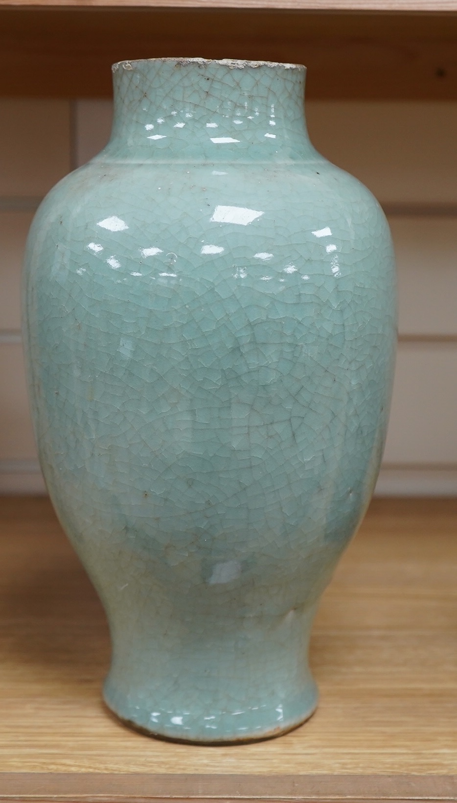 A 17th century Chinese celadon crackle glazed vase, 29cm. Condition - ground down